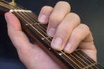 hand playing chord on guitar